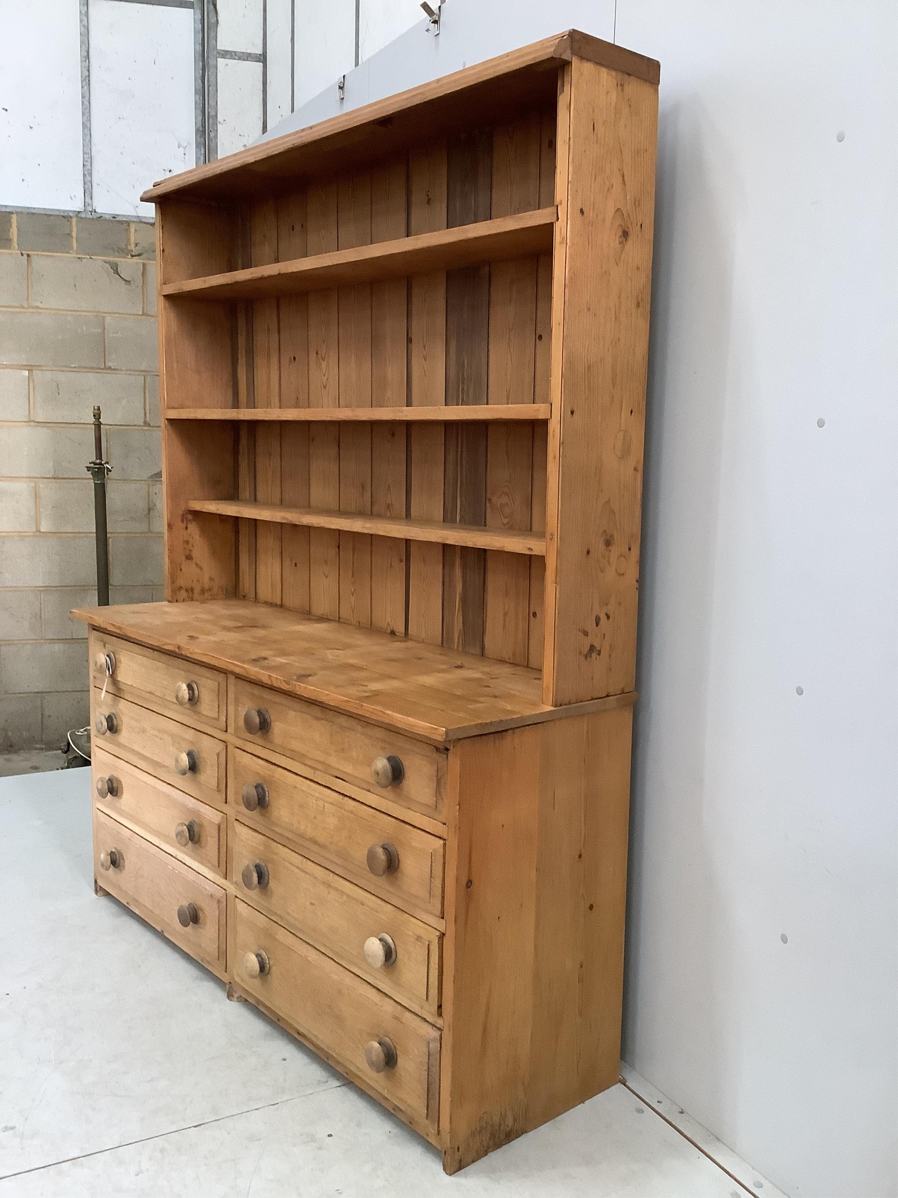 A Victorian style pine eight drawer dresser with boarded rack, width 157cm, depth 50cm, height 197cm. Condition - fair